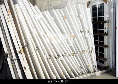 Miami Florida,Habitat for Humanity ReStore,sells donated building materials,tools,appliances,home furnishings,used,stacked door,doors,hinges,white,rem Stock Photo