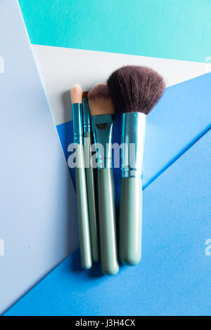 Her Life in Shades of Blue: Still Life of a make-up brush placed on a multi-tone shades of blue. Stock Photo