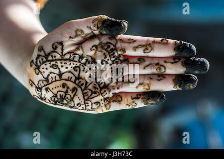 A girl showing his hand decorated with hanna desighn called 'Mehendi' Stock Photo