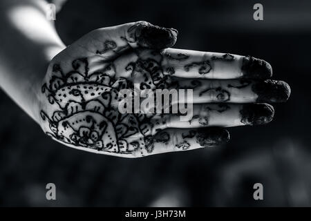 A girl showing his hand decorated with hanna desighn called 'Mehendi' Stock Photo