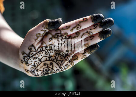 A girl showing his hand decorated with hanna desighn called 'Mehendi' Stock Photo