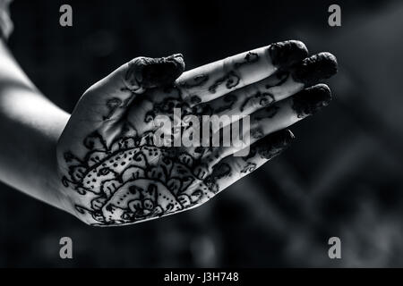 A girl showing his hand decorated with hanna desighn called 'Mehendi' Stock Photo