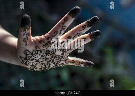 A girl showing his hand decorated with hanna desighn called 'Mehendi' Stock Photo