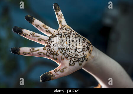 A girl showing his hand decorated with ;Hanna' Stock Photo