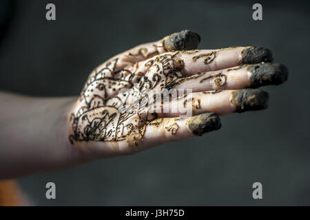 A girl showing his hand decorated with hanna desighn called 'Mehendi' Stock Photo