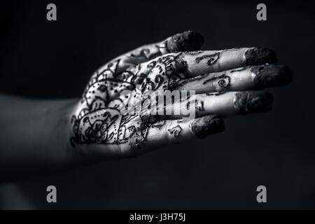 A girl showing his hand decorated with hanna desighn called 'Mehendi' Stock Photo