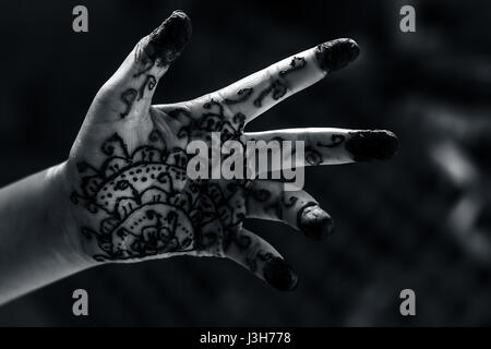 A girl showing his hand decorated with ;Hanna' Stock Photo