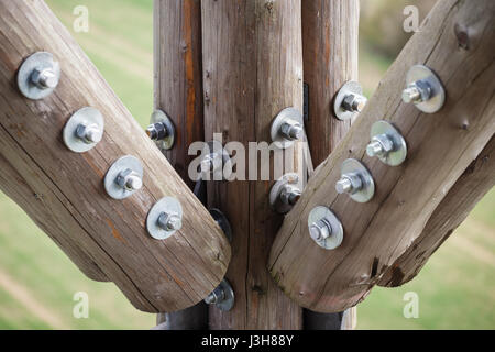 Wooden beams with screws in the structure. Assembly of wooden beams with steel screws. Detail of the observation tower connections. Stock Photo