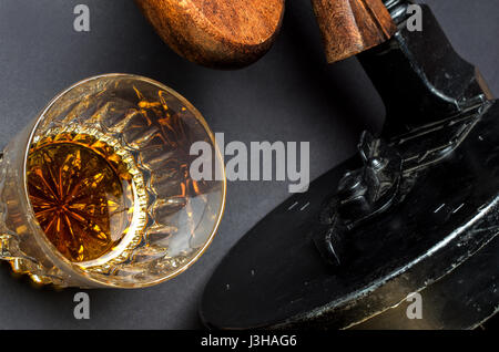 Thompson gun and whiskey glass on black background Stock Photo