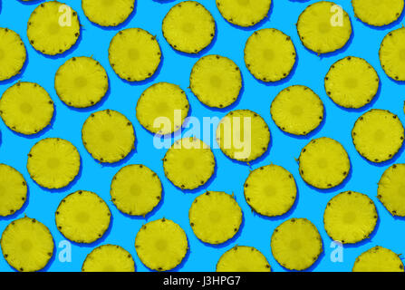Pineapples on blue background, seamless Stock Photo
