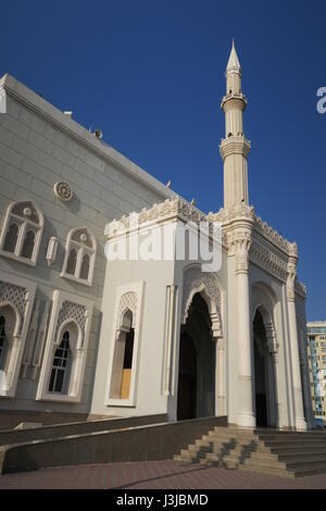 Sharjah is the third largest emirate in the United Arab Emirates. Lots of mighty skyscrapers with glass facades, palm trees, mosques. Nice garden, bay Stock Photo