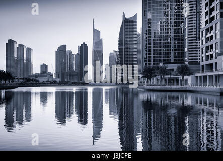 Dusk skyline of Jumeirah lakes towers with clear reflections, Dubai, United Arab Emirates Stock Photo