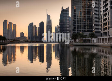 Dusk skyline of Jumeirah lakes towers with clear reflections, Dubai, United Arab Emirates Stock Photo
