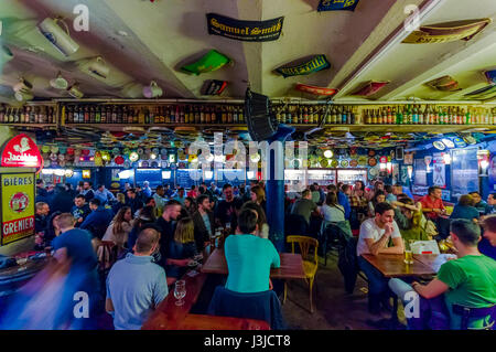 BRUSSELS, BELGIUM - 11 AUGUST, 2015: Famous Delirium Bar inside overview of crowded room of people enjoying their beers. Stock Photo