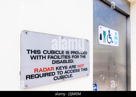 Sign advising people that the disabled toilet is accessible for everyone and that RADAR keys are not required to access this cubicle. Stock Photo