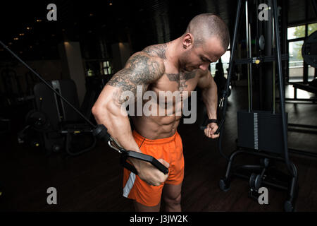 Bodybuilder Is Working On His Chest With Cable Crossover In Gym Stock Photo