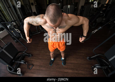 Athlete Is Working On His Chest With Cable Crossover In Gym Stock Photo