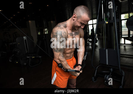 Athlete Is Working On His Chest With Cable Crossover In Gym Stock Photo