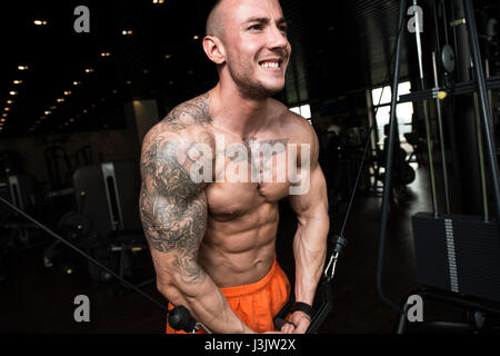 Bodybuilder Is Working On His Chest With Cable Crossover In Gym Stock Photo