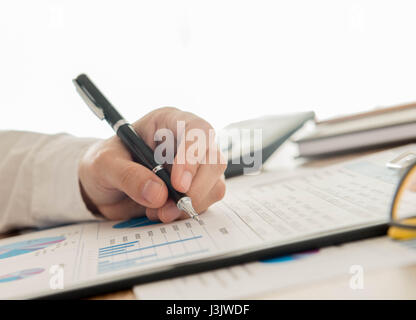 Businessmen are analyzing data from graph reports. Stock Photo