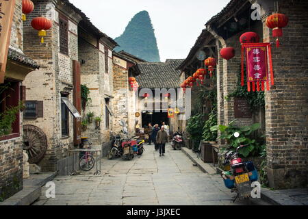 HUZHOU, CHINA - MAY 2, 2017: Residents of Huang Yao Ancient Town in Zhaoping county walking on the traditional Chinese style street Stock Photo