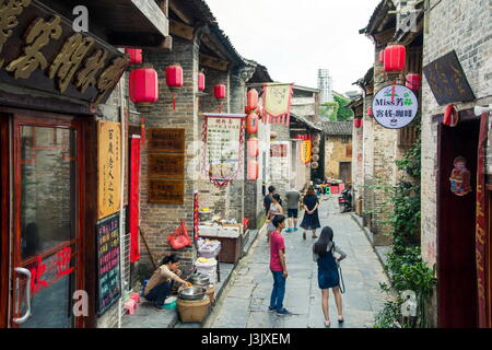 HUZHOU, CHINA - MAY 2, 2017: Tourists walking in the Huang Yao Ancient Town in Zhaoping county, Guangxi province. Traditional Chinese strry style Stock Photo