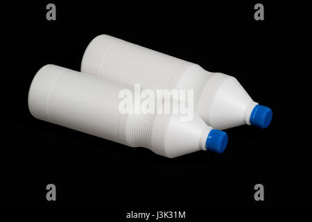 Two white plastic bottles on black background Stock Photo