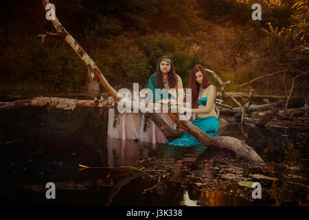 Fairytale woman sad, man holding her hand, they are in a swamp. Stock Photo