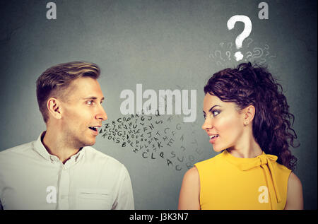 Man talking to an attractive woman with question mark Stock Photo