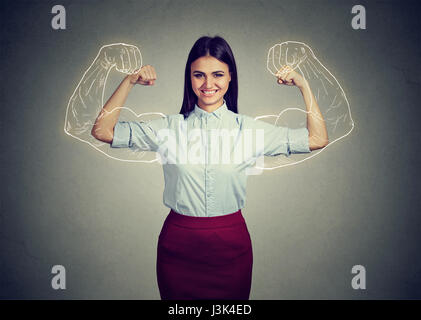 Powerful confident woman flexing her muscles isolated on gray wall background. Human face expressions, emotions Stock Photo