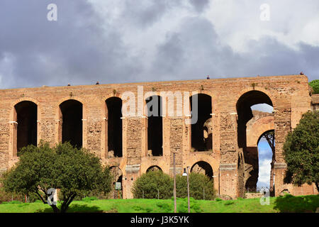 Tourists visit Palatine Hill Imperial Palace monumental arcade in Rome during a cloudy day Stock Photo