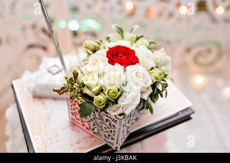 Set of wedding rings in Red and white rose taken closeup. wedding concept. selective focus. flower arrangement box for rings accessories. the ceremony of marriage Stock Photo