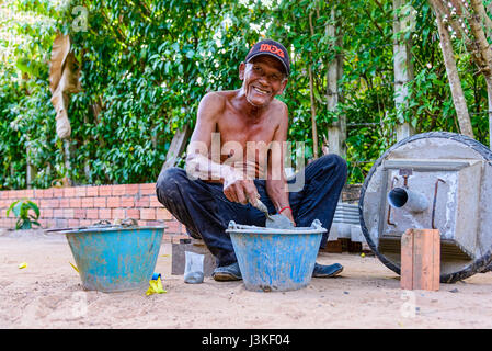 Siem Reap, Cambodia - January 5, 2017: Portrait of an unidentified elder Khmer man working with cement Stock Photo