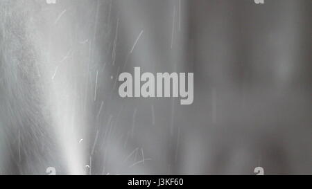 Aerosol can being sprayed against a black background Stock Photo - Alamy