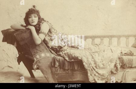 This image from the Harvard Theatre Collection shows Sarah Bernhardt in the role of Cleopatra. The cropped photograph highlights Bernhardt's dramatic portrayal of the iconic historical figure, showcasing her theatrical presence. Stock Photo
