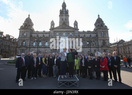 First Minister Nicola Sturgeon (centre left) with Susan Aitken, the new leader of SNP group on Glasgow City Council at a photo call with the SNP's new council group in Glasgow's George Square to mark the party's victory in the Scottish local elections. Stock Photo