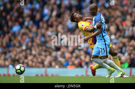 Crystal Palace's Wilfried Zaha and Manchester City's Fernandinho battle for the ball during the Premier League match at the Etihad Stadium, Manchester. Stock Photo