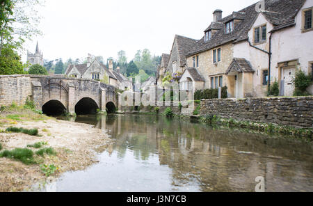 CASTLE COMBE, UK - MAY 1, 2017: River Bybrook and bridge in Castle Combe, Wiltshire, UK Stock Photo