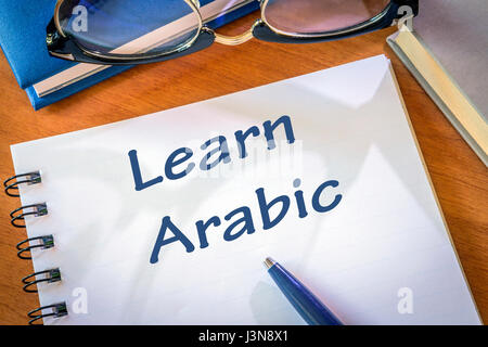 Learn arabic written in a notepad. Education concept Stock Photo