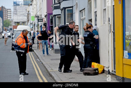 Brighton, UK. 6th May, 2017. Police arrest and lead a woman away after an incident in George Street Kemp Town Brighton this afternoon Credit: Simon Dack/Alamy Live News Stock Photo