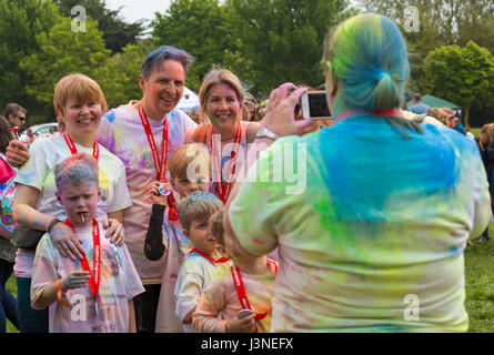 Weymouth, Dorset, UK. 6th May, 2017. Weldmar's Colour Run takes place at Weymouth to raise funds for the charity. Families participate in the event and have fun getting covered in brightly coloured powder paint. Taking a photo of family covered in powder paint. Credit: Carolyn Jenkins/Alamy Live News Stock Photo