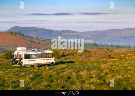 Flintshire, North Wales,  UK Weather, Clear blue sky over Flintshire this morning despite a cold start it will warm up throughout the day. Sunrise over rural Flintshire this morning near to the village of Halkyn and a perfect view for these overnighters to wake up to with Clwydian Range hills in the distance Stock Photo