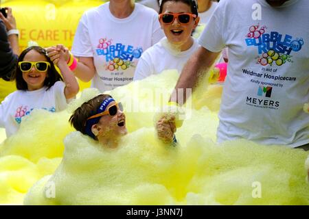 Weymouth, Dorset, UK. 7th May, 2017. Hundreds of sponsored runners take part in a the Weldmar Bubble Rush in Weymouth. The event, which involved a 4km run passing through a series of colours bubble stations where participants are covered coloured foam raised funds for the Weldmar Hospicecare Trust, Credit: Tom Corban/Alamy Live News Stock Photo