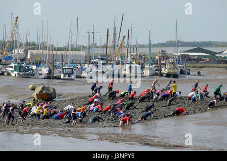 Maldon, Essex, UK. 7th May, 2017. Hundreds of competitors take part in the 2016 Maldon Mud race at Promenade Park Maldon Essex. The race is run on a 450 metre course on the River Blackmore and can only take place at low tide. This event began in 1973, when a local man was challenged to don a tuxedo to serve a meal on the bank of the river.  This later led to a race across the river where locals had to drink a pint from a waiting barrel of beer before racing back again.This years race was contested by nearly 300 competitors  and 10,000 spectators. Credit: MARTIN DALTON/Alamy Live News Stock Photo
