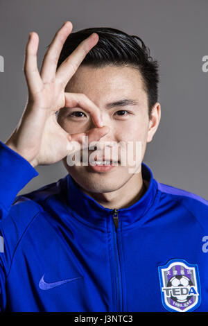 Portrait of Chinese soccer player Li Zheng of Tianjin TEDA F.C. for the 2017 Chinese Football Association Super League, in Tianjin, China, 26 February 2017. Stock Photo