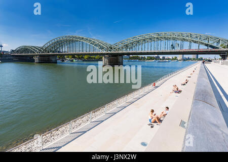COLOGNE - SEPTEMBER 6: People enjoying the sun on the new Rhine River promenade in front of the Hohenzollern Bridge in Cologne in Germany on September Stock Photo