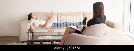Psychologists office, male patient talking about problems to fem Stock Photo