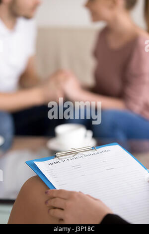 Couple counselling. Female psychotherapist with clipboard and ha Stock Photo