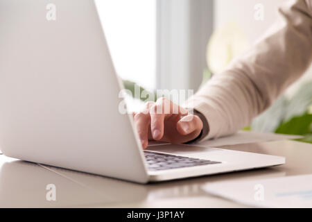 Close up of businessman working on laptop computer at office Stock Photo