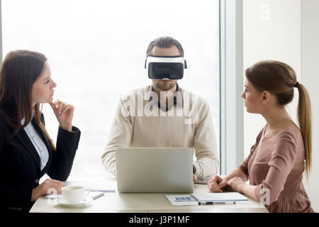 Man wearing VR headset, team developing virtual reality glasses  Stock Photo